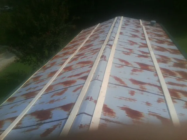 Rusted metal roof panels with new wood purlins before replacement — Storm Damage Roof Repair in New Berlin by Roofing Brothers